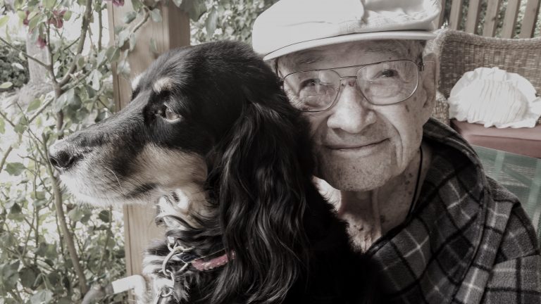 Elderly man with pet dog